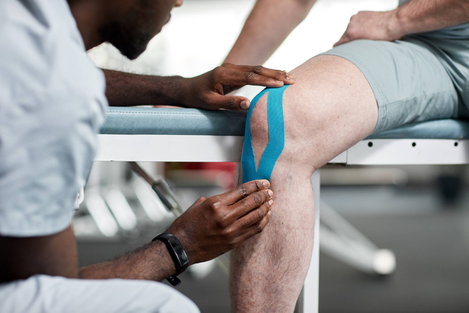 Man having leg muscle taped